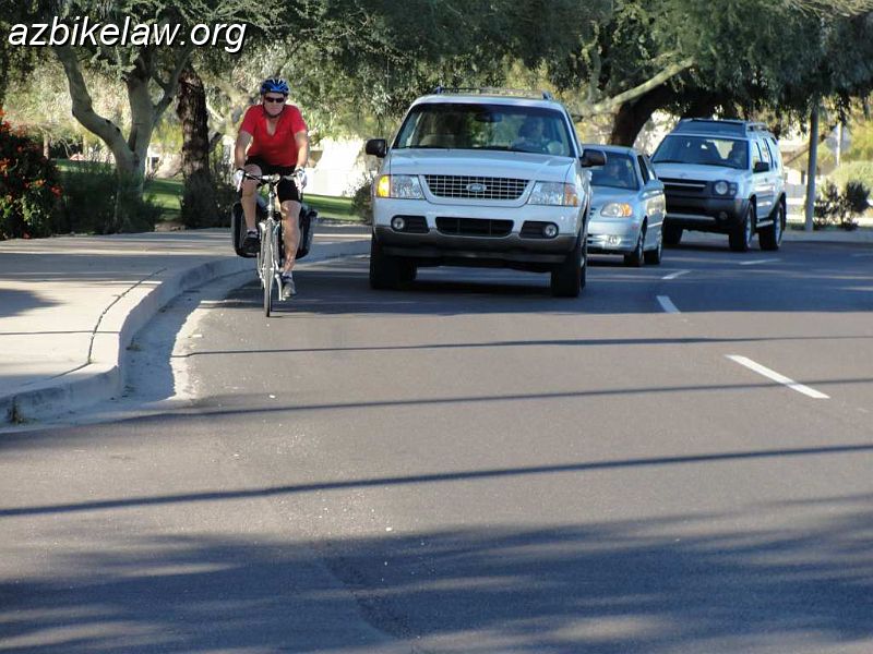 DSC01578-.JPG - Nothing special; the cyclist is positioned too far to the right. The white SUV is waiting behind cyclist, as appropriate, to make the next right.