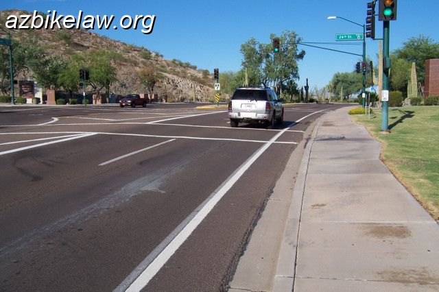 chand2.jpg - Chandler Blvd westbound, near 24th Street.This is where the massively wide (~ 35') landscaped median begins, extending westward from here out to Desert Foothills Parkway... Though there is "no room" for a bike lane, only this small shoulder (~ 2.5 feet).